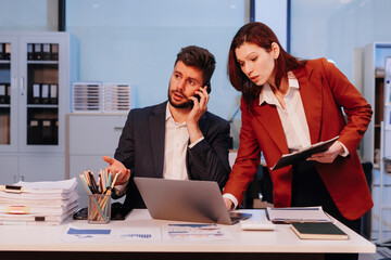 Project manager working overtime and update tasks with milestones progress planning and professional investor working new start up project in the office.