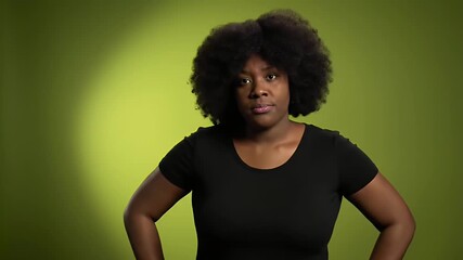 Confident Black Woman in Black T-Shirt Posing Against a Lime Green Studio Backdrop with Hands on Hips Radiating Self-Assurance and Empowering Body Positivity Campaign Presentation