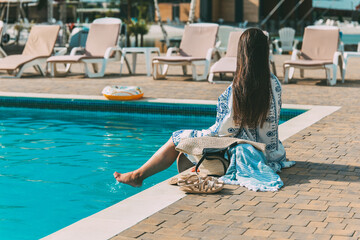 Woman enjoying a sunny day by the pool