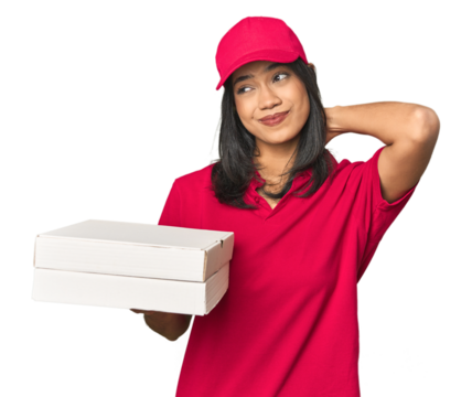 Latina delivering pizza, studio setup touching back of head, thinking and making a choice.