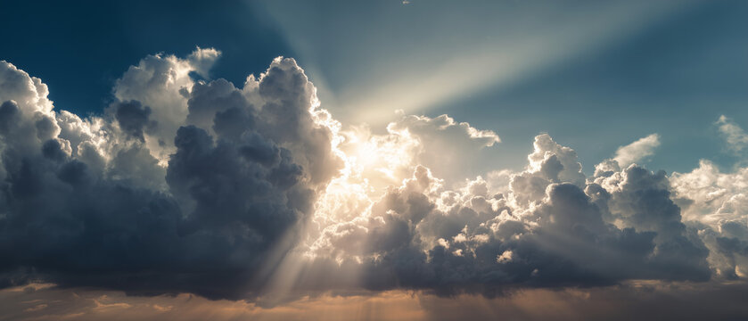 Dramatic Sky with Golden Sun Rays Through Majestic Clouds