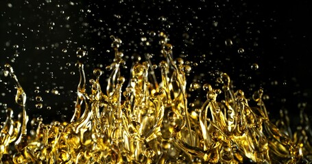 Freeze Motion of Abstract Oil Splashes on Black Background. Oil Drops Flying up in the Air. Concept of Beauty, Serum, Fuel or Fry.