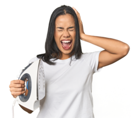 Latina with iron, studio setup covering ears with hands trying not to hear too loud sound.