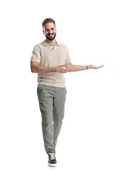 casual young man with glasses smiling and presenting to side