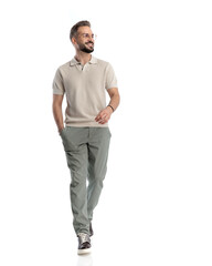 bearded casual man with glasses walking and looking to side