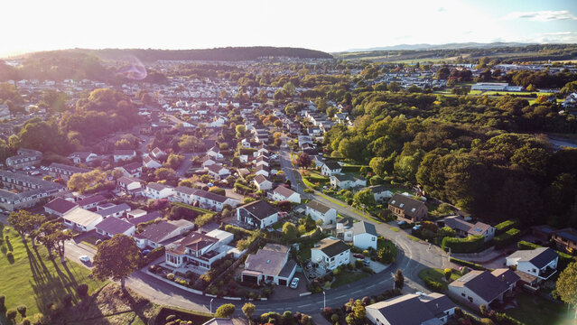 Aerial photo showcasing the entire residential area and townscape of Dalgety Bay, Fife, Scotland. High-angle view perfect for depicting coastal town planning and suburban life.
