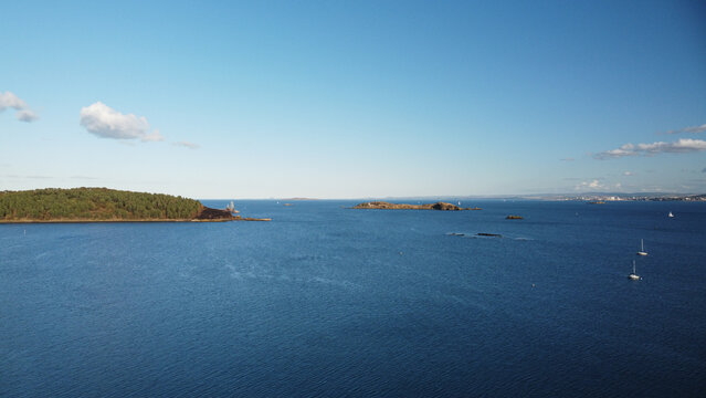 Wide panoramic view of the Firth of Forth, featuring Inchcolm Island and its famous Abbey. Captured from the scenic coastline of Dalgety Bay, Fife, Scotland.