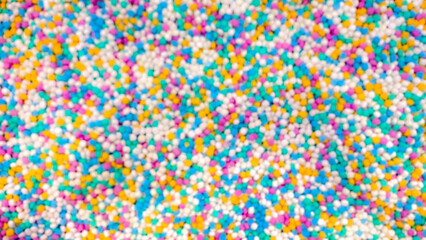 Blurred image of colorful decorative stones, creating soft abstract bokeh pattern background for design and texture.