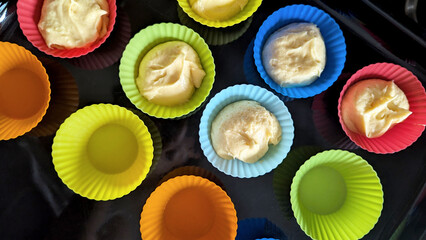 Colorful Silicone Baking Cups with Raw Cupcake Batter Ready for Oven
