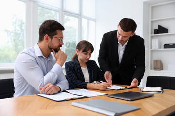 Couple having meeting with business consultant at table in office
