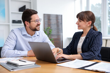 Fototapeta premium Consultant working with client at table in office. Business meeting