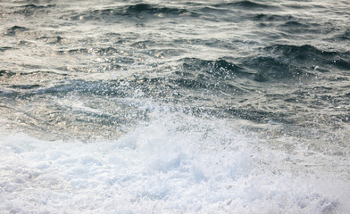 The ocean is calm and peaceful, with a few small waves breaking on the shore