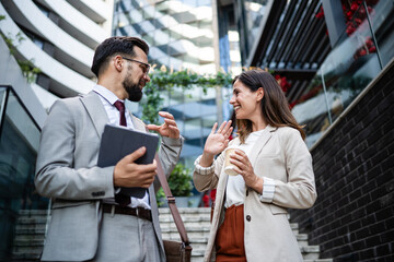 Business people talking and gesturing in urban setting