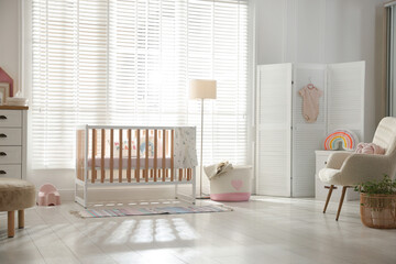 Stylish baby's room with crib. Interior design