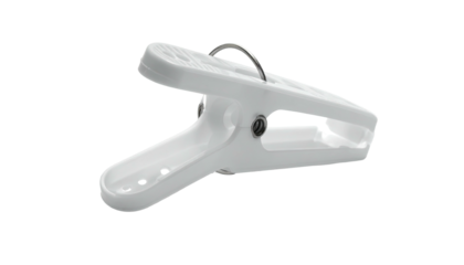 A white plastic clip with a silver metal hinge resting against a black background