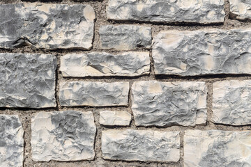 The background old gray stony wall