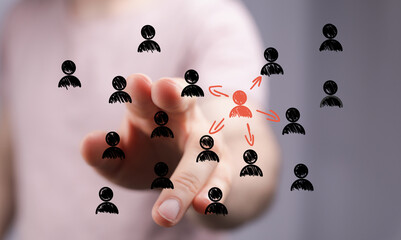 Hand pointing at central figure in network,leadership, connection, teamwork concept.