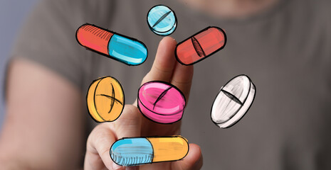 Hand interacting with colorful pills and capsules.  Medical, healthcare, pharmacy concept.