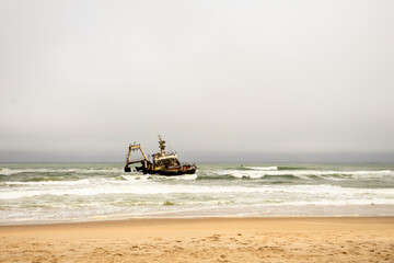 The Zeila shipwreck off Namibia’s Skeleton Coast, rusting in the Atlantic surf under cloudy skies