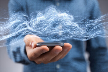 Close-up of a man's hand holding a smartphone surrounded by digital magnetic radiation. Blur backdrop.