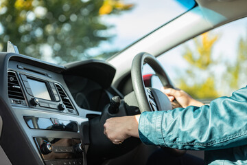 Close-up Of Person's Hand Inserting Key To Start Car. Woman's hand starts a car with the key.