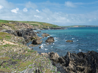 Rocky coastline against a bright blue sea.