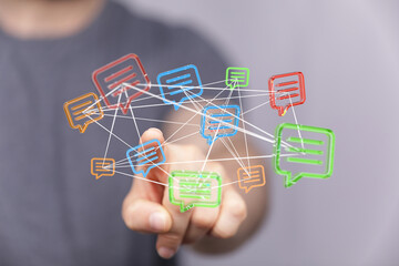 A hand interacts with interconnected message bubbles, symbolizing communication and global network connections. Ideal for illustrating social me