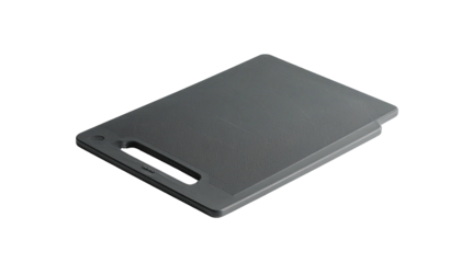 A rectangular, gray kitchen cutting board with a handle, angled against black