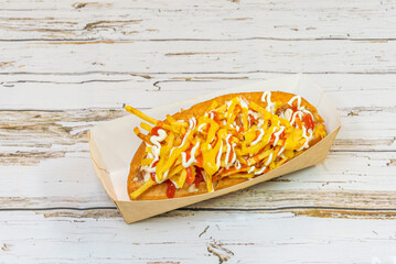 Full Chilean hot dog with mashed avocado, diced tomatoes, sauerkraut, and homemade mayonnaise,...