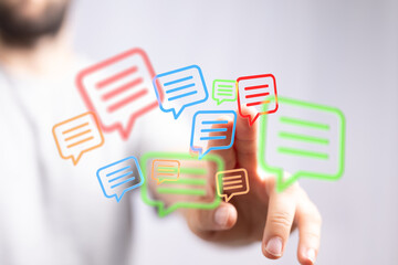 Conceptual image of online messaging with a person touching a chat bubble, representing digital dialogue and connection.