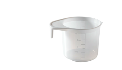 White transparent plastic measuring cup with handle against a black background