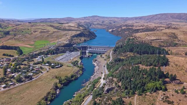 Dynamic drone footage racing toward the Roxburgh Dam on New Zealand&rsquo;s Clutha River, highlighting the hydroelectric infrastructure and surrounding landscape.