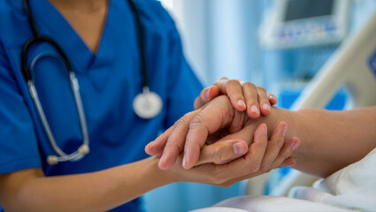 A nurse gently holds a patients hand, conveying compassion, care, and support in a hospital setting, emphasizing the human connection in healthcare