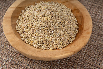 Pearl barley grains. Raw peeled cereal pile texture, organic pearl barley