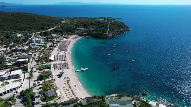 Quiet Ionian Beach in Albania with Turquoise Water, Bars and restaurants offer Tourists Relaxing