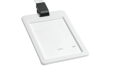 Angled shot of a white ID badge with a black clip on a white lanyard
