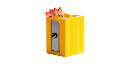 A small yellow plastic pencil sharpener with shavings against a black background