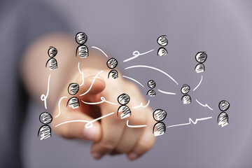 Hand interacting with a digital network of interconnected people, symbolizing global teamwork,...