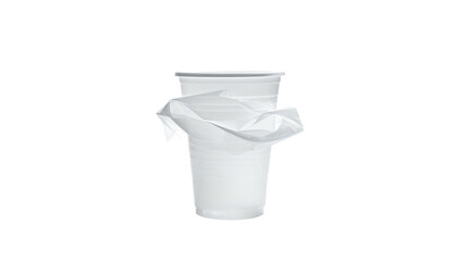 A translucent white plastic cup with crumpled tissue on a stark black background