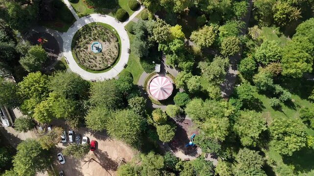 Aerial top-down view of vintage carousel in Tei Park, Bucharest, Romania on a sunny September day  v3
