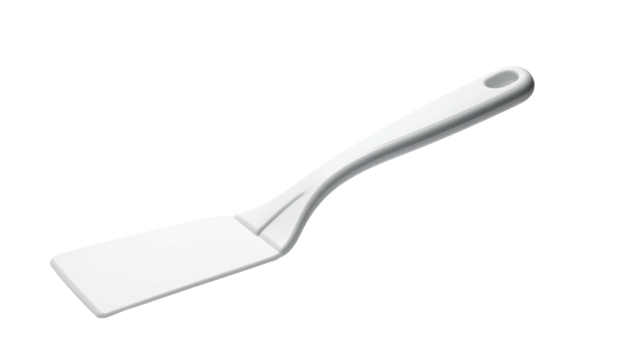 A simple, white kitchen spatula rests at an angle against a stark, black background