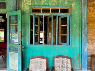 Outdoor seating outside of vintage rural home retro caf&eacute; with rustic wood and weathered wood cladding. Unique antique vintage corner, with aesthetic and beauty.