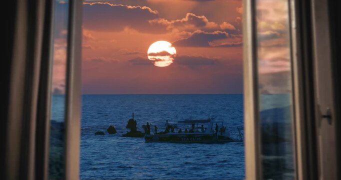Sunset at sea beyond the window