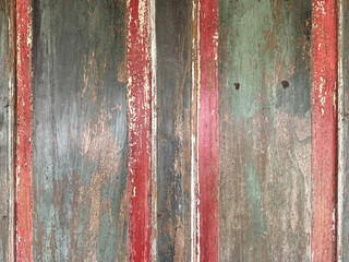 Close up of colorful vibrant rustic wood door panel with carving and red frame. In rustic brown wood, and corroded rusty colors and red paint. Old vintage, traditional, and retro feel. Seamless