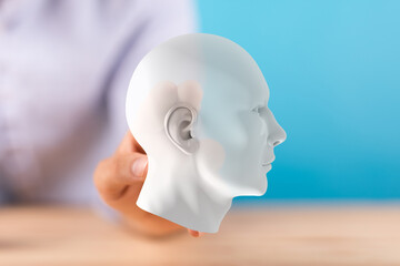 3D human head model held in hand.  Concept for AI, intelligence, mind, thinking, innovation.