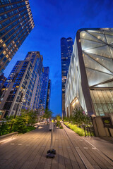 Wide view of the elevated urban park with skyscrapers and nighttime ambiance in Manhattan
