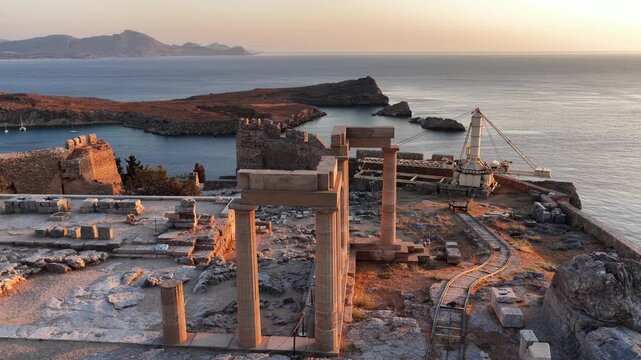 Breathtaking aerial view of Lindos in Rodos Greece at sunset highlighting ancient ruins and stunning coastline