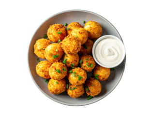 Golden-brown, crispy bite-sized balls atop a gray plate, with a side of creamy sauce