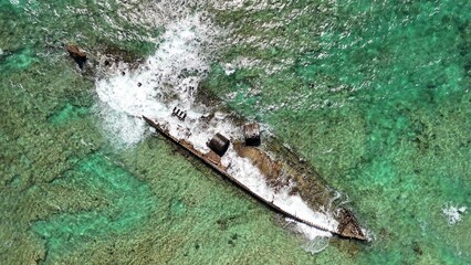 Drone shot of Mildura Wreck resting in shallow turquoise waters near Exmouth shoreline