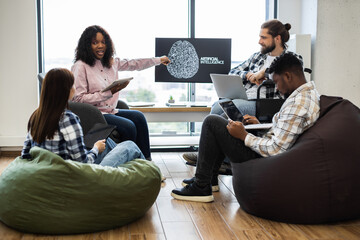 Diverse group of young professionals brainstorming artificial intelligence development project modern workspace